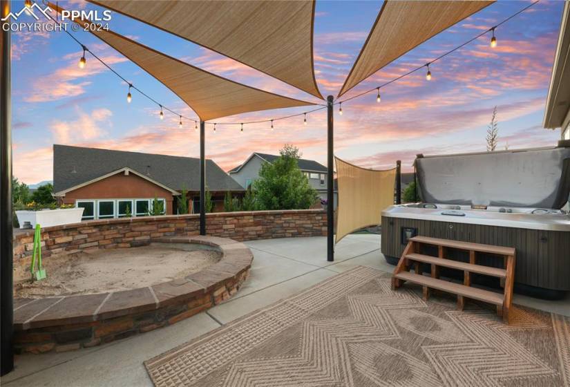 Patio terrace at dusk with a hot tub