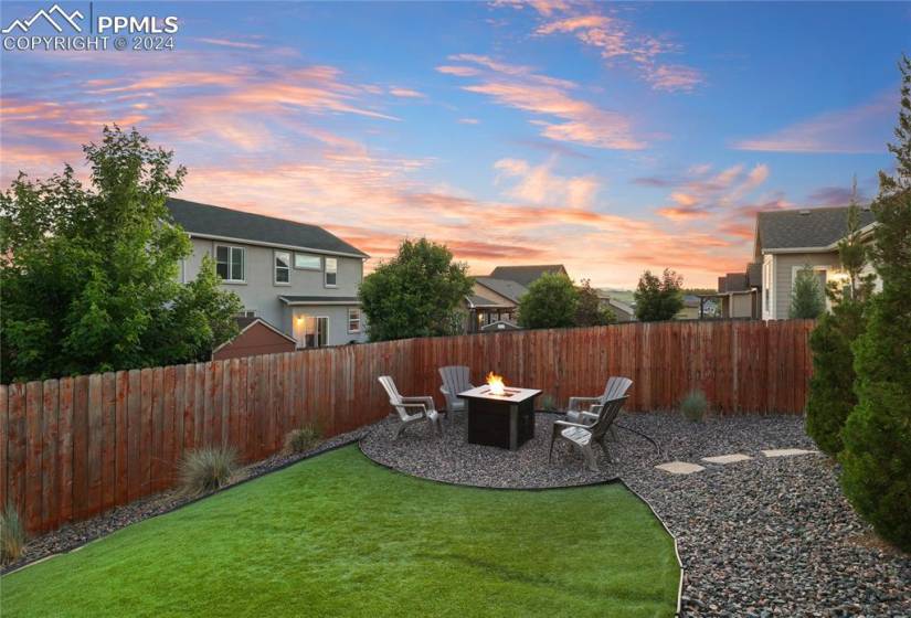 Yard at dusk featuring an outdoor fire pit and a patio area