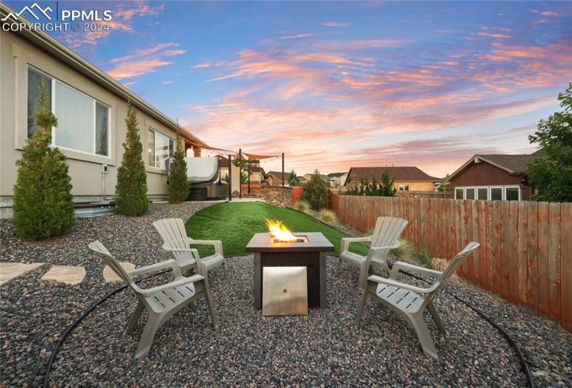 Yard at dusk with a patio area and a fire pit