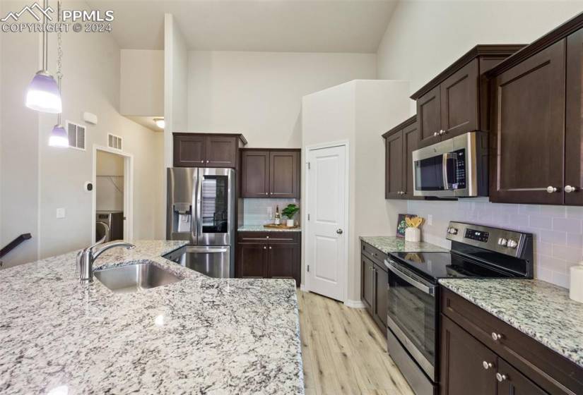 Kitchen With Timeless Backsplash, Stainless Steel Appliances, and Walk In Pantry