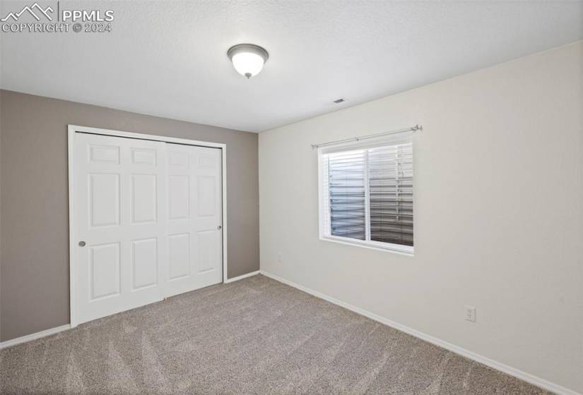 Unfurnished bedroom featuring a closet and carpet