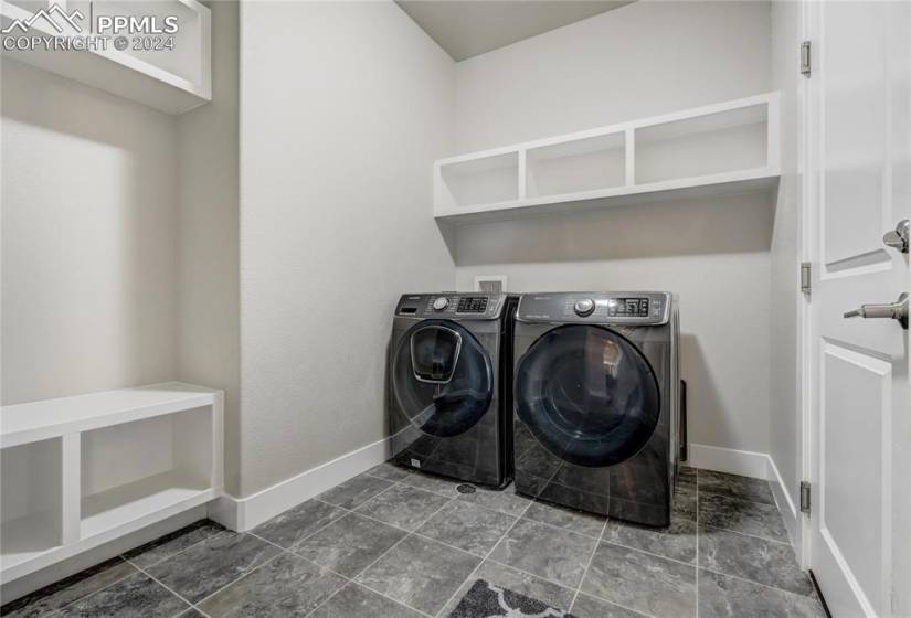 Main Level Laundry/Mud Room with Built-in Cubbies, Entry to Garage + Tile Floor