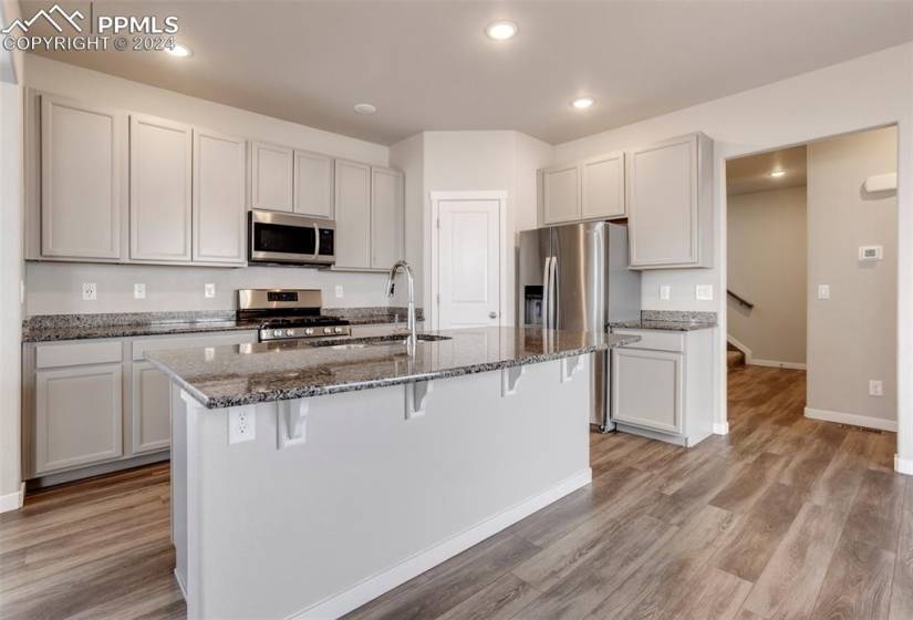 Beautifully appointed kitchen includes gas stove and stainless appliances.