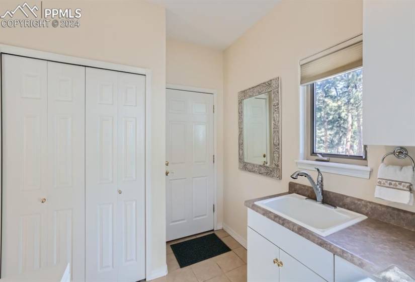 Light and bright laundry room with extensive storage and closet off the kitchen hook ups for washer and gas or electric dryer.