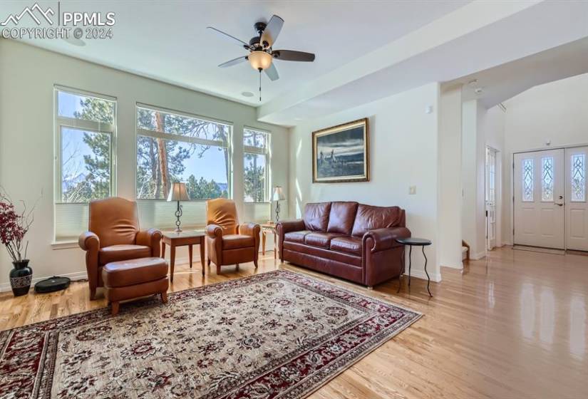 Living room featuring hardwood flooring, plenty of natural light, Views, and ceiling fan