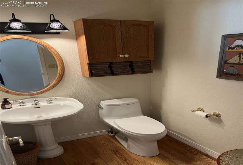 1/2 Bathroom with hardwood flooring