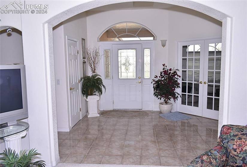 Tiled foyer entrance featuring french doors and plenty of natural light