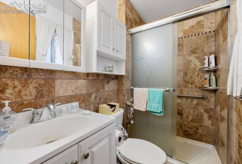 The Primary Shower Bathroom features a vanity, mirrored medicine cabinet, and enclosed tiled shower.