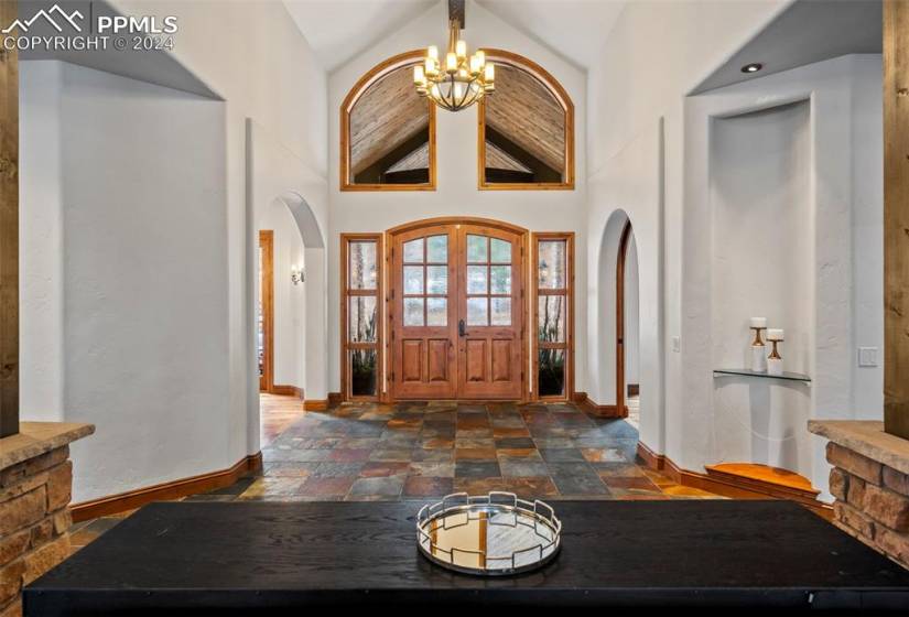 Grand foyer entrance with an inviting chandelier and high vaulted ceiling