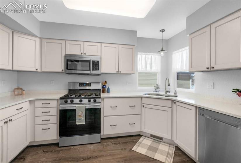 Kitchen featuring new white cabinets, LVP Flooring and stainless steel appliances