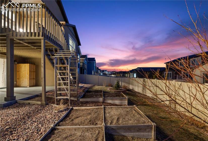 Yard at dusk with a patio and garden area