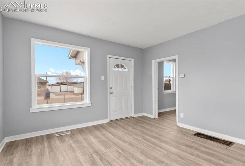 Foyer with light hardwood / wood-style floors