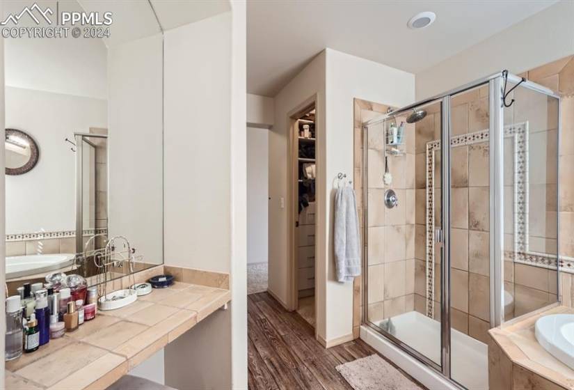 Bathroom with plus walk in shower and wood-type flooring