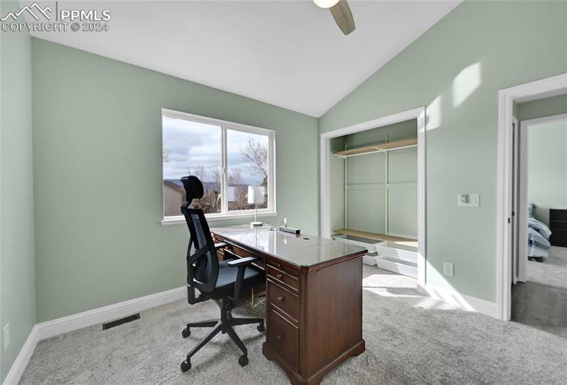 Office space with vaulted ceiling, light hardwood / wood-style floors, and ceiling fan