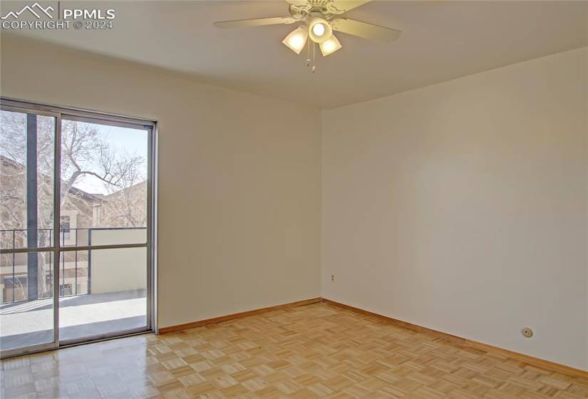 Unfurnished room featuring ceiling fan, light parquet floors, and a wealth of natural light