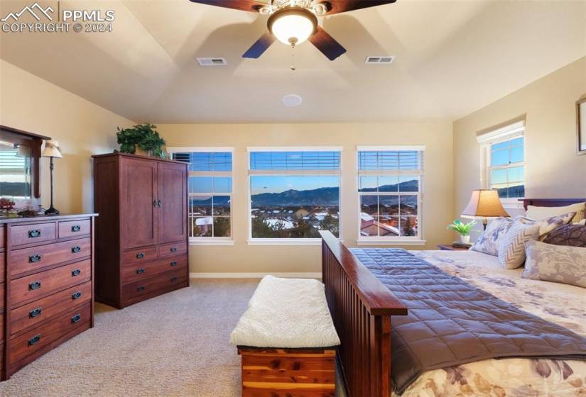 Carpeted bedroom featuring a mountain view and ceiling fan