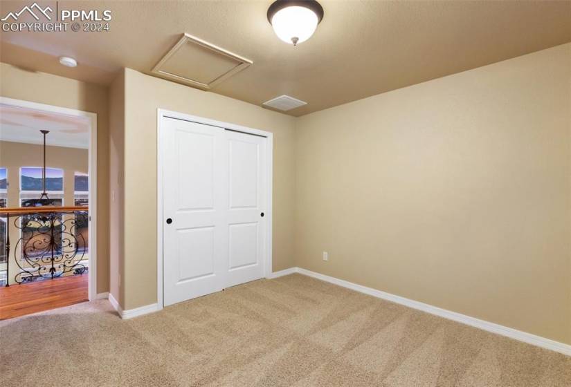 Upper bedroom with a closet and light carpet