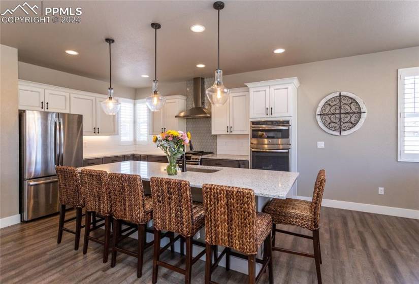 Large kitchen with stainless steel appliances and a 9.5ft center island with seating