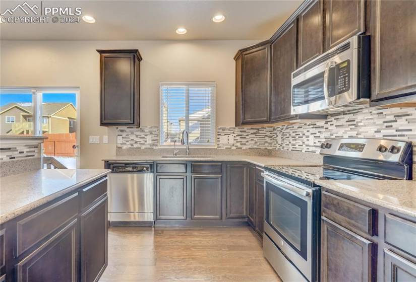 Stainless Steel Appliances include Range/Oven, Dishwasher, Refrigerator + Microwave