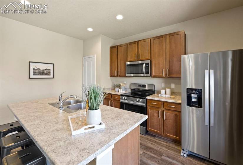 Kitchen has stainless steel appliances, brand new oven and a pantry