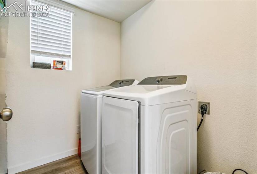 Washroom featuring hookup for an electric dryer, washer and clothes dryer, and hardwood / wood-style floors