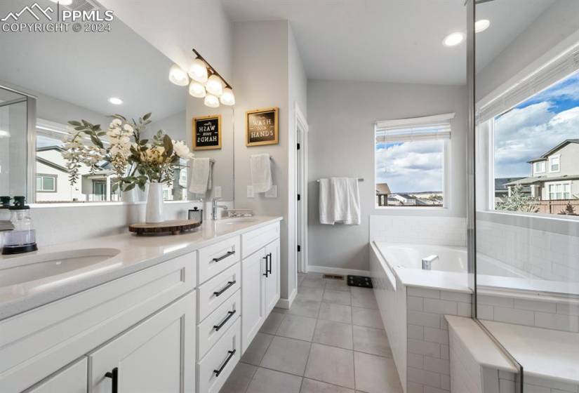 Primary Bath has dual sinks, soaking tub and walk in shower