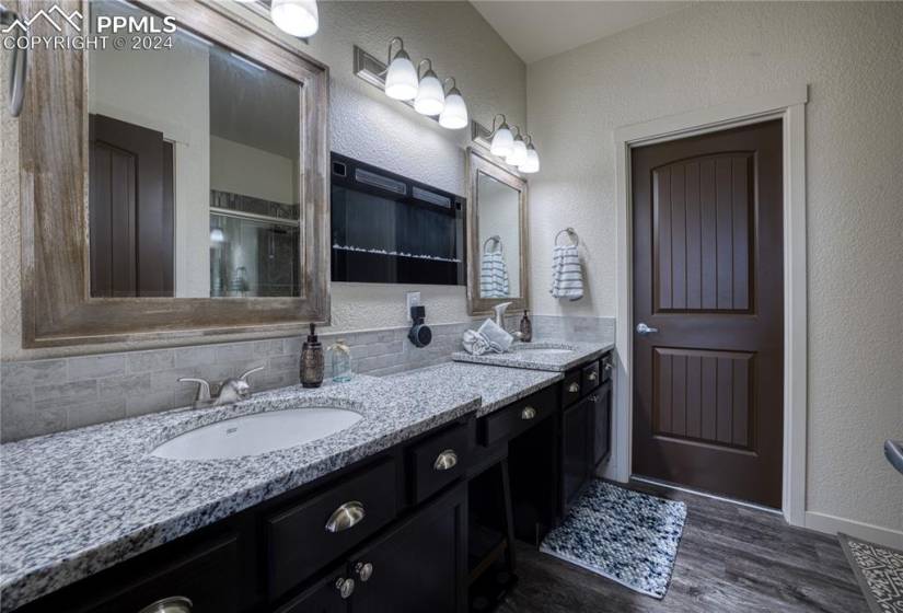 Primary Bathroom with dual sink vanity, make-up area, and framed mirrors.