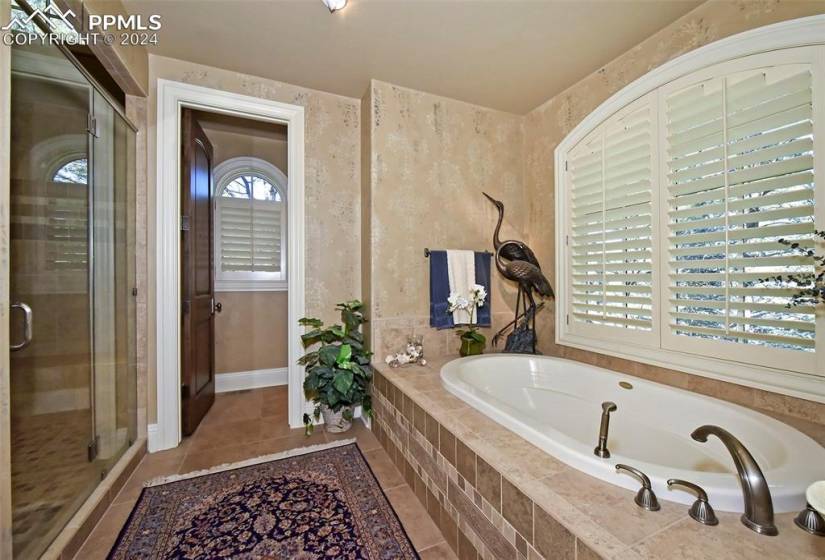 Bathroom featuring plus walk in shower and tile floors
