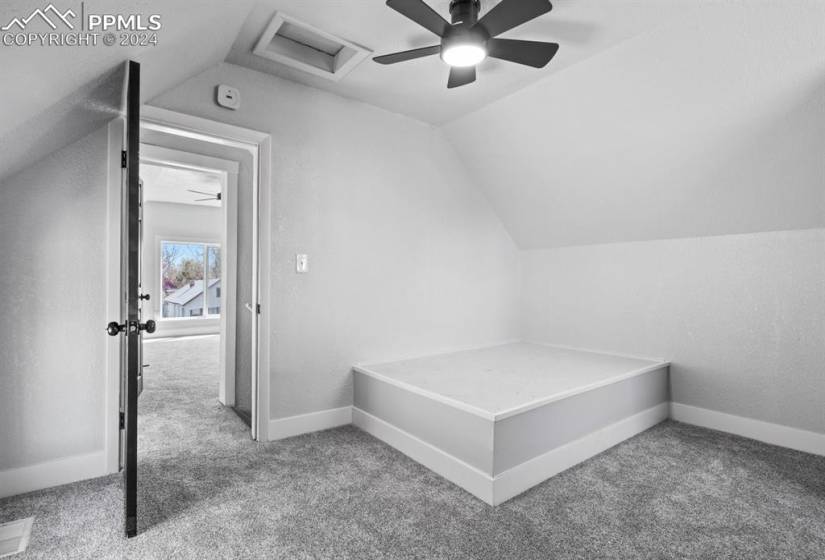 Bedroom with light carpet, lofted ceiling, and ceiling fan