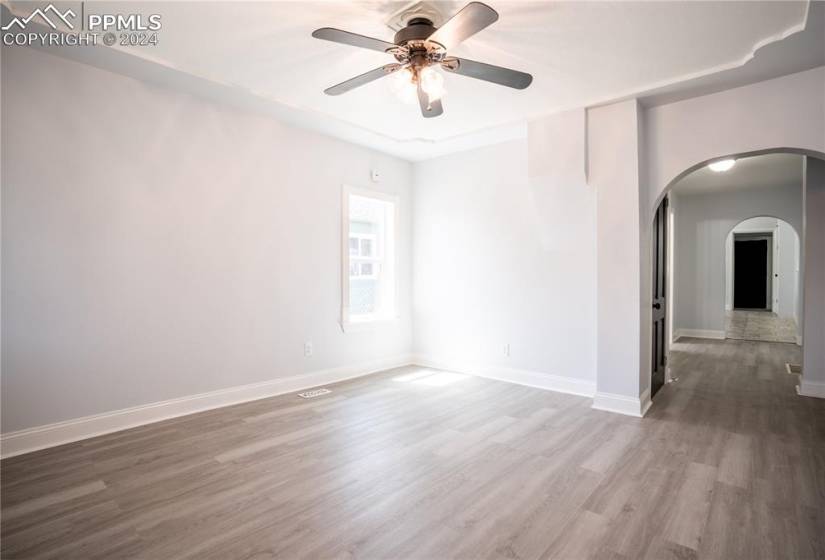 Empty room with dark hardwood / wood-style flooring and ceiling fan