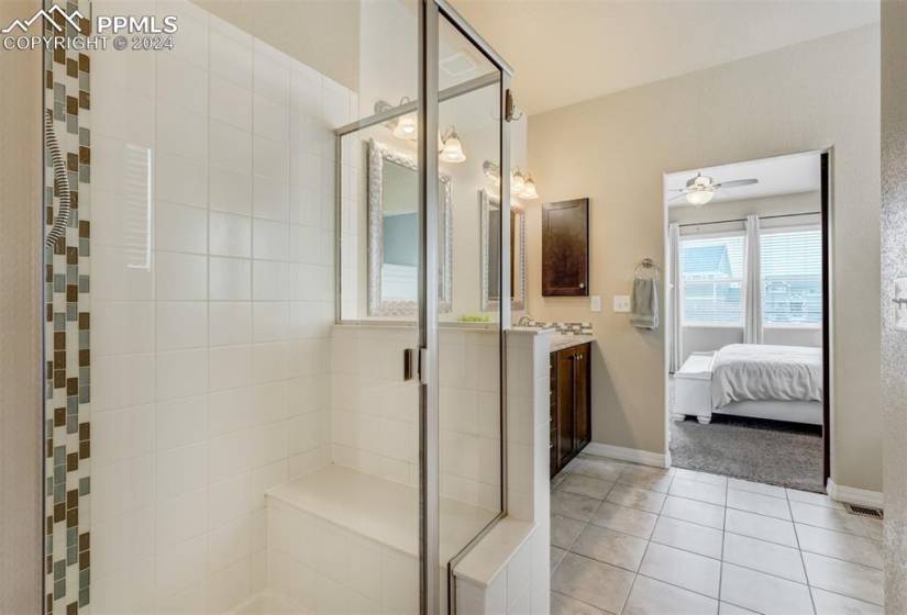Standing shower with tile accent.
