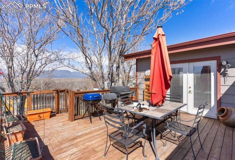 Deck with a mountain view and area for grilling