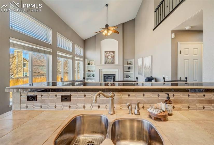 The kitchen opens to the family room with soaring ceilings