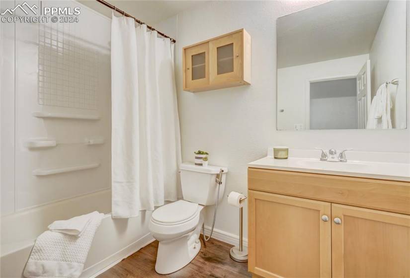 Full bathroom featuring shower/bath combo, located in the basement