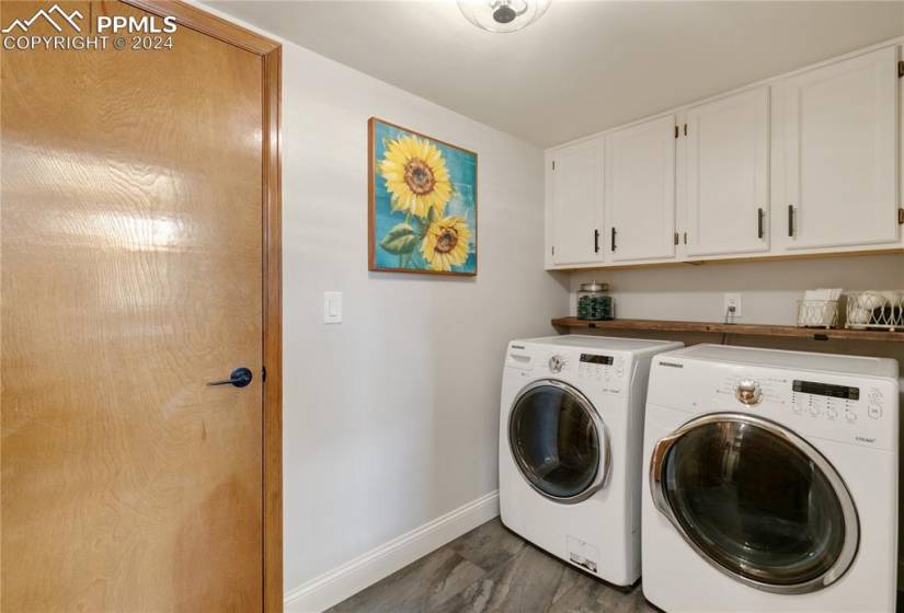 Laundry area featuring cabinets, separate washer and dryer, and small pantry