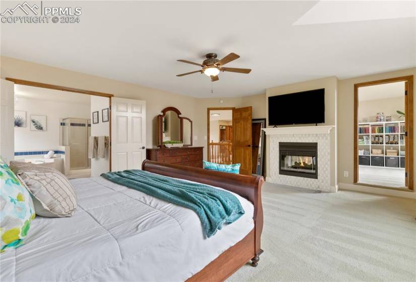 Primary bedroom featuring ceiling fan, 5 Piece Bath, Walk-in closet, window seat and fireplace