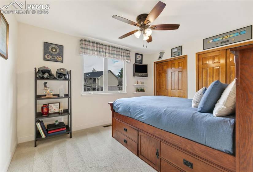 Secondary bedroom with two closets and ceiling fan