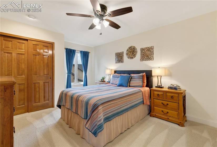 Secondary bedroom featuring a closet and ceiling fan