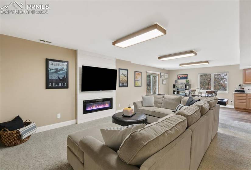 Family room featuring fireplace and game room and kitchenette