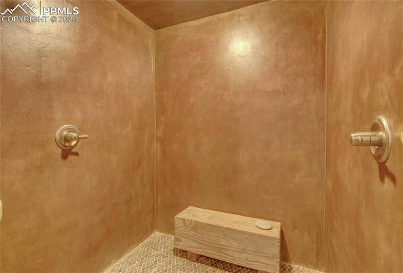 Bathroom featuring tile flooring and a shower