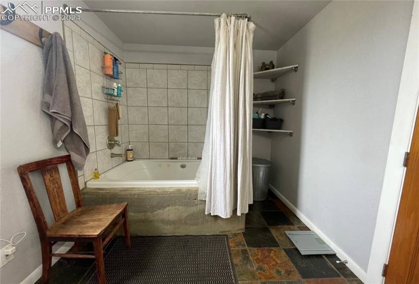 Bathroom with tile floors and shower / tub combo