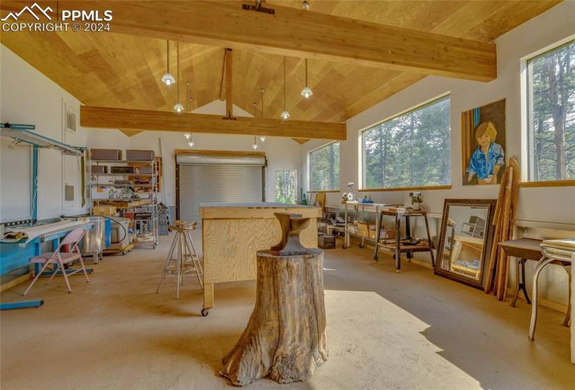 Misc room featuring plenty of natural light, wooden ceiling, and vaulted ceiling with beams