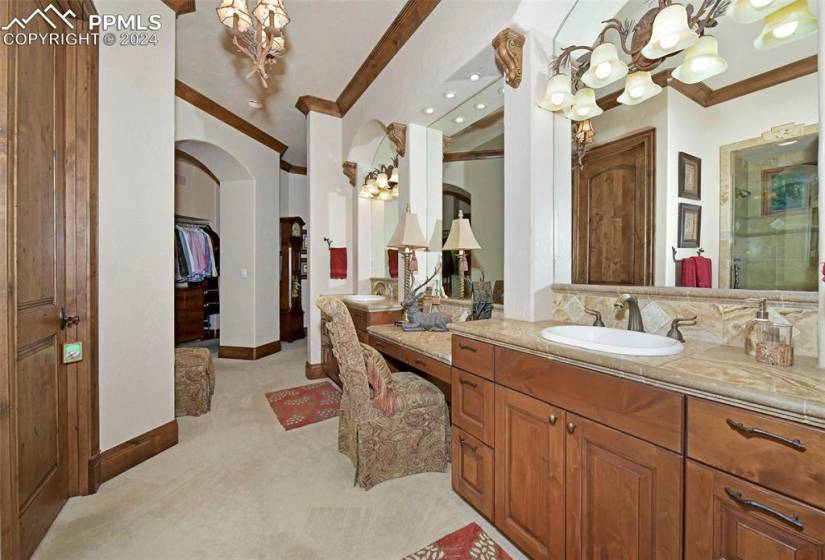 Bathroom with walk in shower, vanity, and ornamental molding