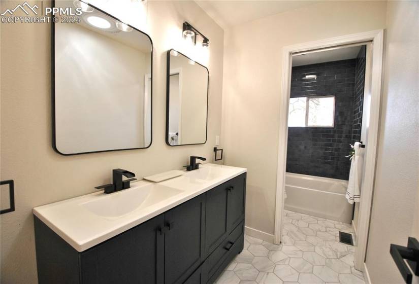 Updated bathroom featuring dual vanity