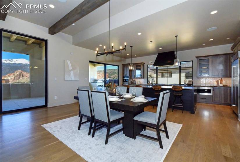 Dining space featuring white oak floors,Pikes Peak & Garden of the Gods Views, 10+ ft beamed ceilings, and easy access to the Chefs Kitchen or your custom bar