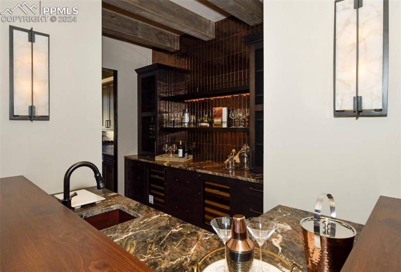 Your custom Bar features beamed ceiling, walnut bar, bar sinks, double beverage centers, 2 refrigerator drawers, ice maker, custom display spaces, wood cabinetry and lots of storage areas