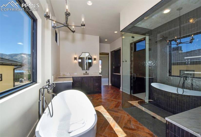 Master Bathroom is a true Retreat with  2 Walkin Closets, dedicated laundry plus oversize walk in shower, soaking tub, custom flooring, a mountain views and double vanities