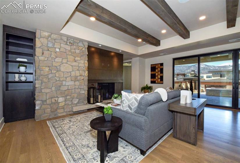 Family room with light hardwood / wood-style flooring, a fireplace, and a mountain view