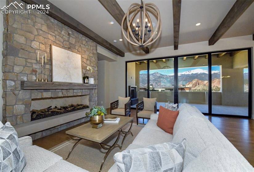 After taking the elevator to your Upstairs Living room enjoy the custom fireplace, white oak flooring, custom programable lighting, 10 ft+ beamed ceiling,and Pikes Peak and Garden of the Gods Views