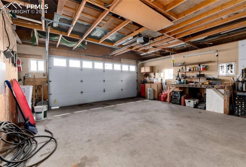 30 x 36' Garage featuring a garage door opener and a workshop area
